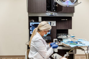 Dr. Little preparing for teeth cleaning