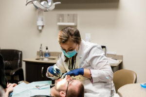 Dr. Bright inspecting teeth