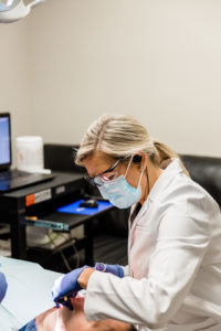 Dr. Little inspecting mouth
