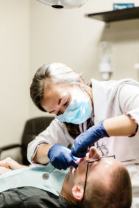 Dr. Bright inspecting teeth